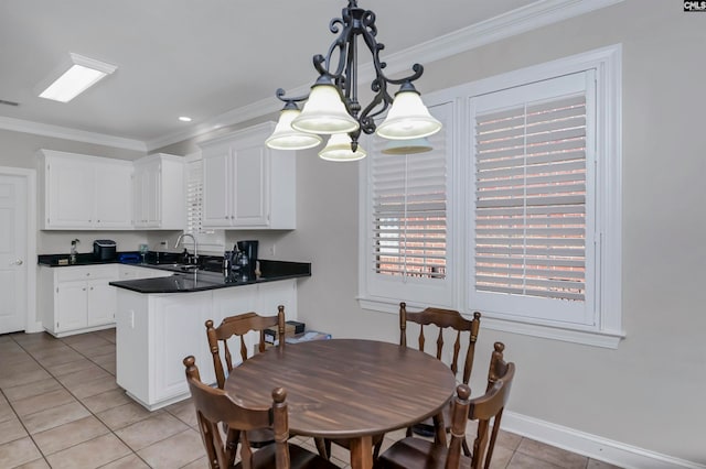 tiled dining area featuring ornamental molding, an inviting chandelier, and sink