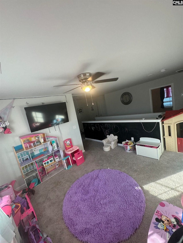 playroom with ceiling fan and carpet