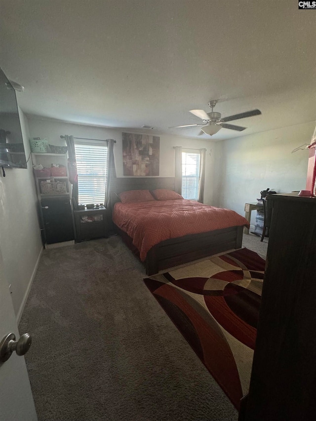 bedroom featuring carpet floors, multiple windows, and ceiling fan