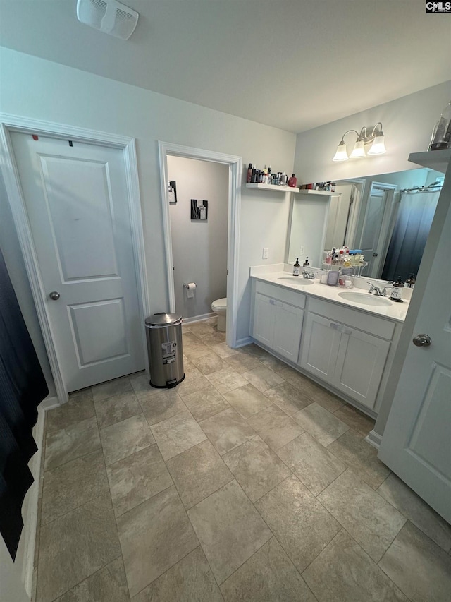 bathroom with vanity and toilet