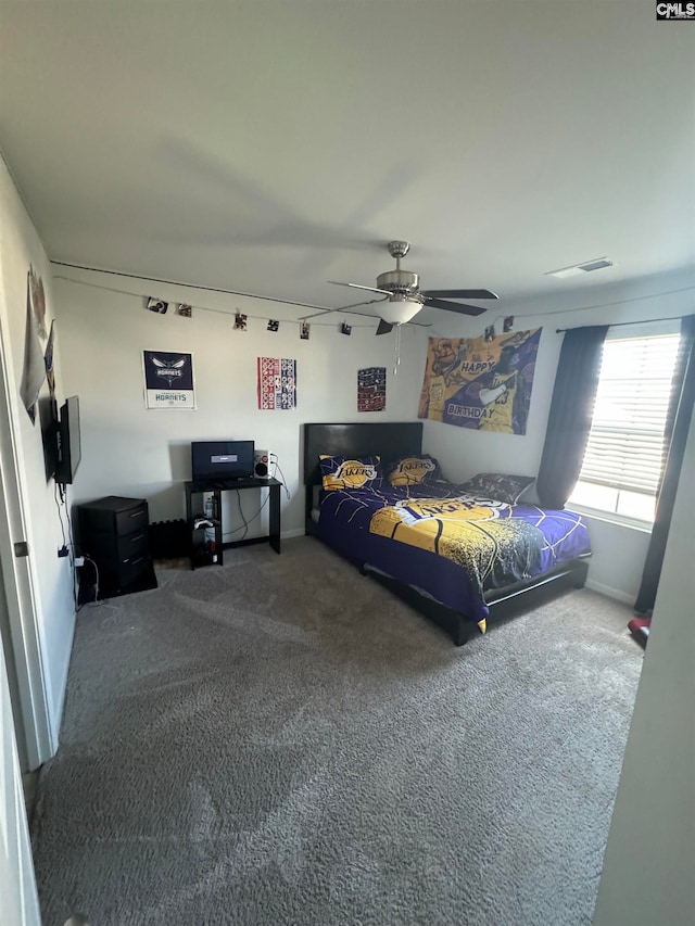 bedroom featuring ceiling fan and carpet