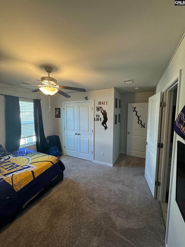 unfurnished bedroom featuring ceiling fan, a closet, and carpet