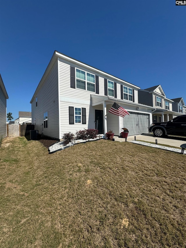 view of front of house with a garage and a front lawn