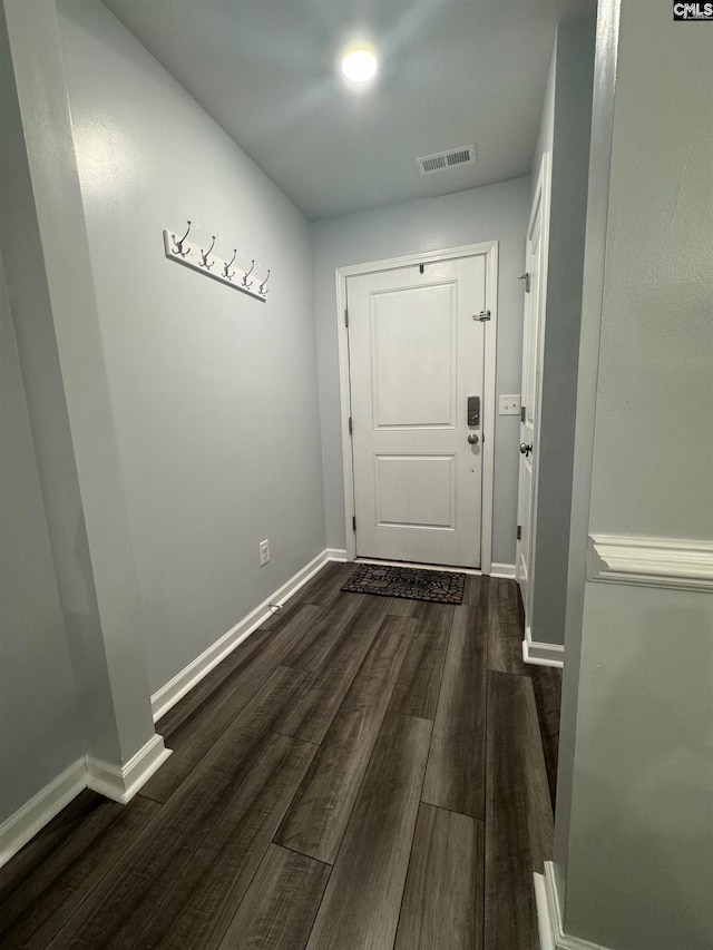 doorway to outside with dark wood-type flooring