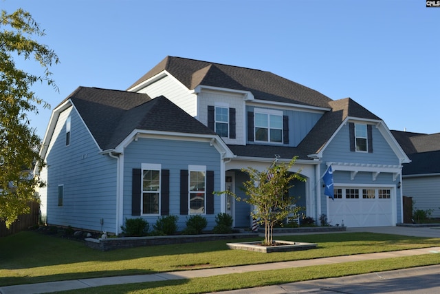 view of front of property with a front lawn and a garage