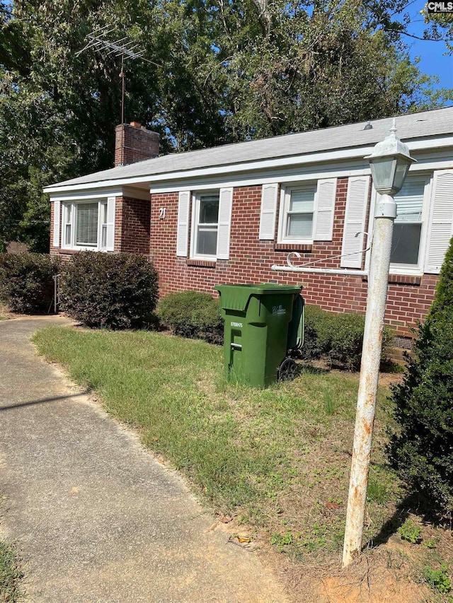 view of side of property featuring a yard