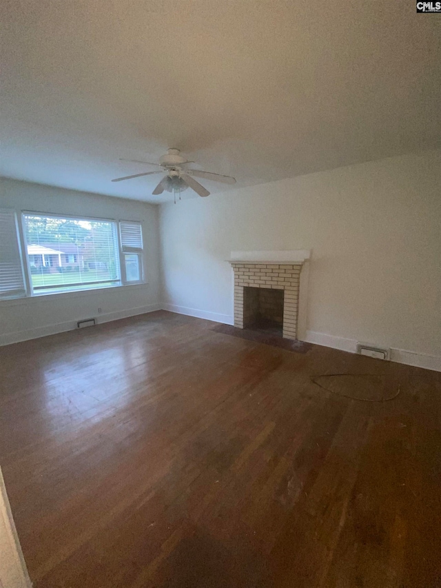 unfurnished living room with a brick fireplace, ceiling fan, and hardwood / wood-style floors