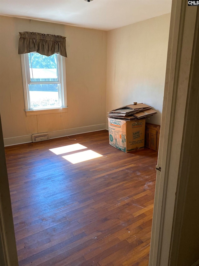 spare room featuring dark hardwood / wood-style floors