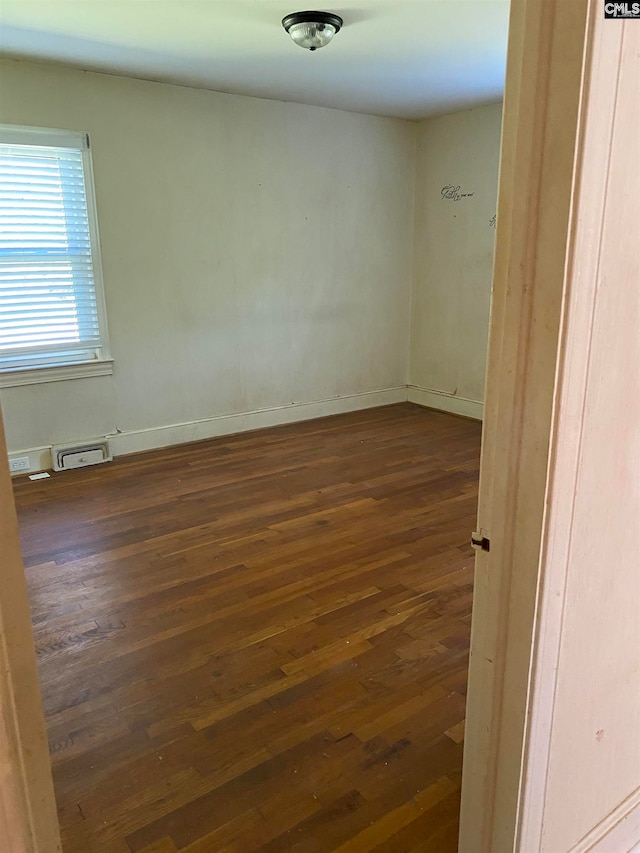 unfurnished room featuring dark hardwood / wood-style floors