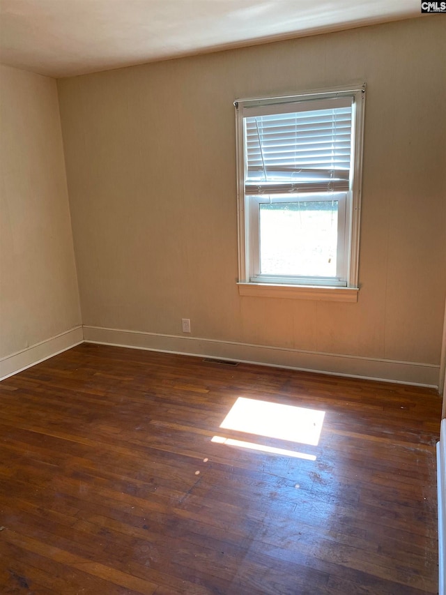 empty room featuring dark hardwood / wood-style flooring