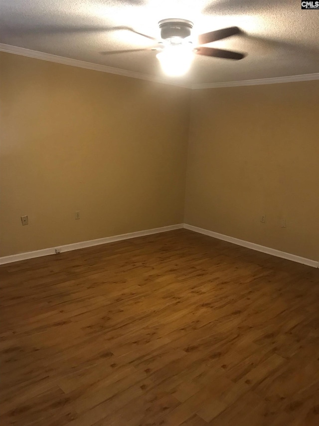 empty room with ceiling fan, a textured ceiling, crown molding, and dark wood-type flooring