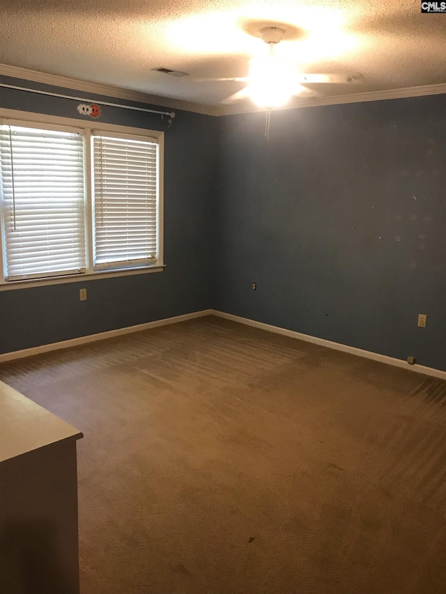 empty room with ceiling fan, carpet flooring, crown molding, and a textured ceiling