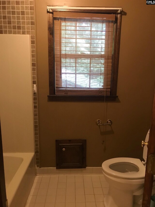 bathroom with plus walk in shower, tile patterned floors, and toilet