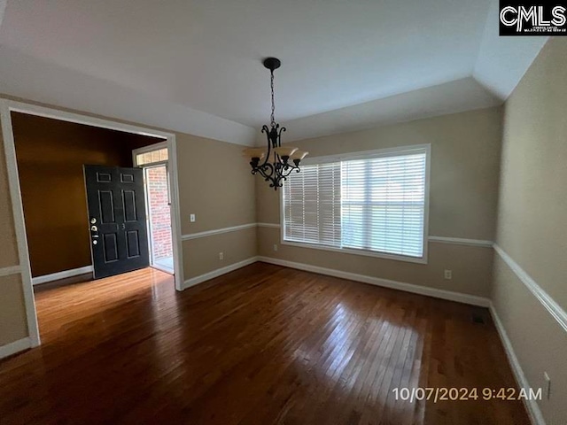 interior space featuring hardwood / wood-style floors and a chandelier