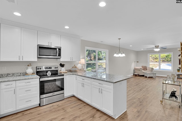 kitchen featuring appliances with stainless steel finishes, kitchen peninsula, light hardwood / wood-style floors, and white cabinets