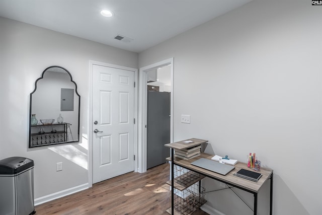 office area with electric panel and wood-type flooring