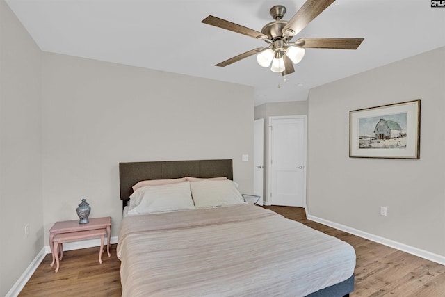 bedroom with ceiling fan and wood-type flooring