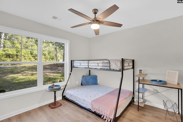 bedroom with ceiling fan and hardwood / wood-style floors