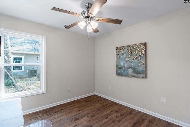 spare room with dark hardwood / wood-style flooring and ceiling fan