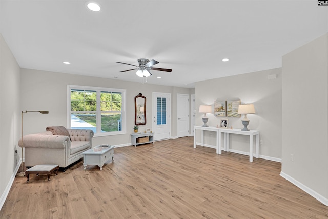 living area featuring ceiling fan and light hardwood / wood-style floors