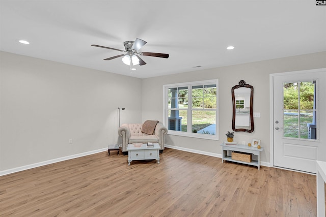 living area featuring ceiling fan and light hardwood / wood-style flooring