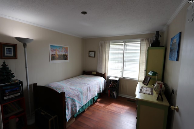 bedroom with hardwood / wood-style flooring, crown molding, and a textured ceiling