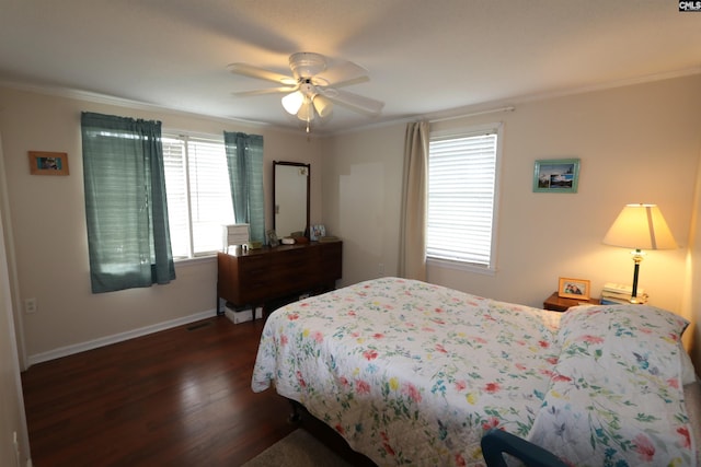 bedroom with dark wood-type flooring, ornamental molding, and ceiling fan