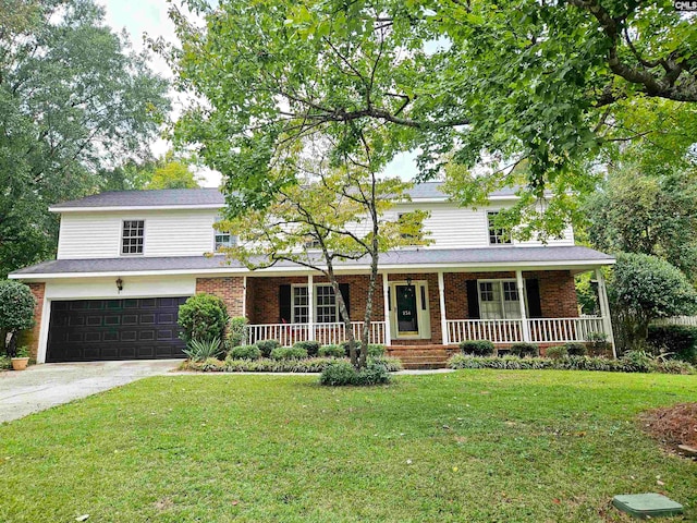 view of front of home with a garage, a front lawn, and a porch