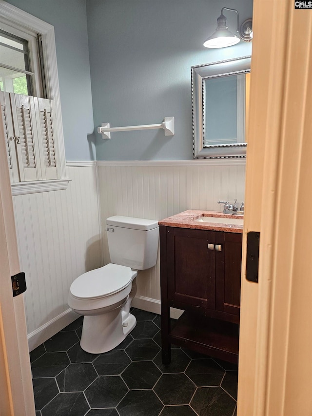 bathroom with tile patterned floors, vanity, and toilet