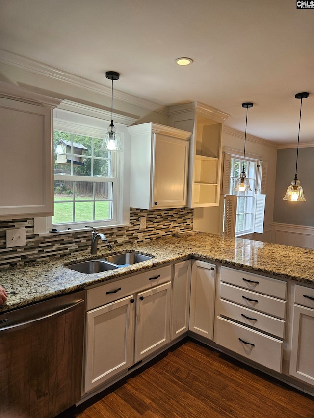 kitchen featuring pendant lighting, dark wood-type flooring, white cabinets, and sink