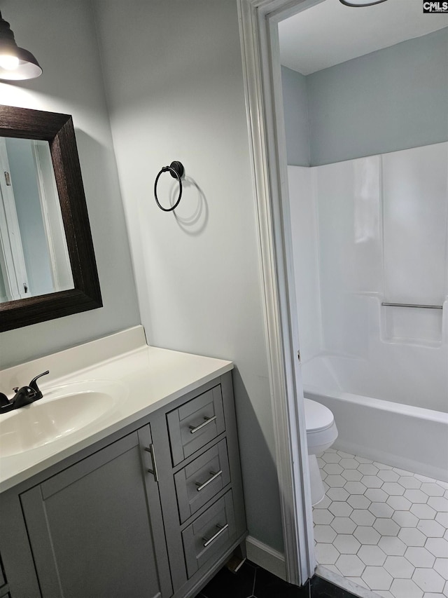 full bathroom featuring vanity, bathing tub / shower combination, toilet, and tile patterned floors