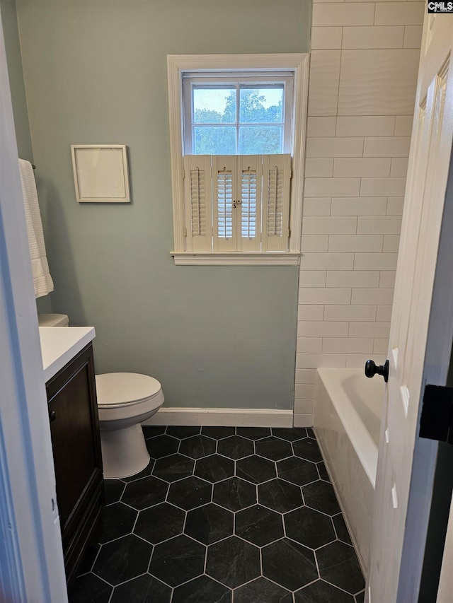 bathroom featuring tile patterned floors, vanity, and toilet