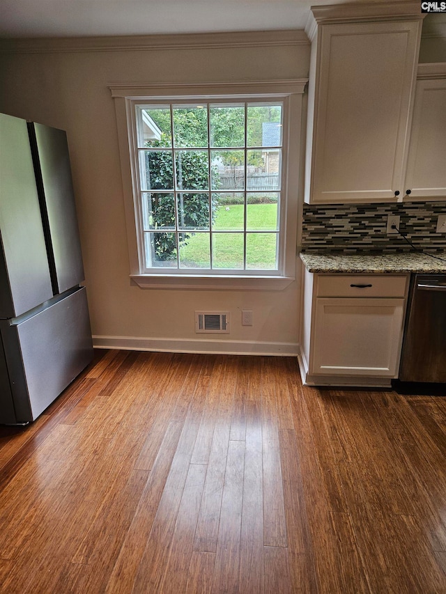 unfurnished dining area featuring crown molding and light hardwood / wood-style floors