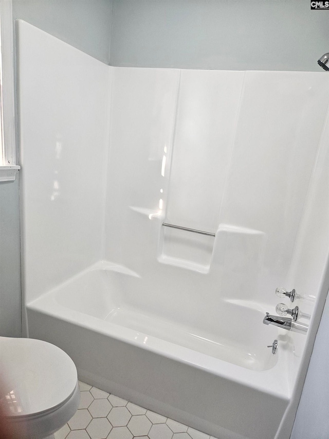 bathroom featuring bathtub / shower combination, toilet, and tile patterned floors