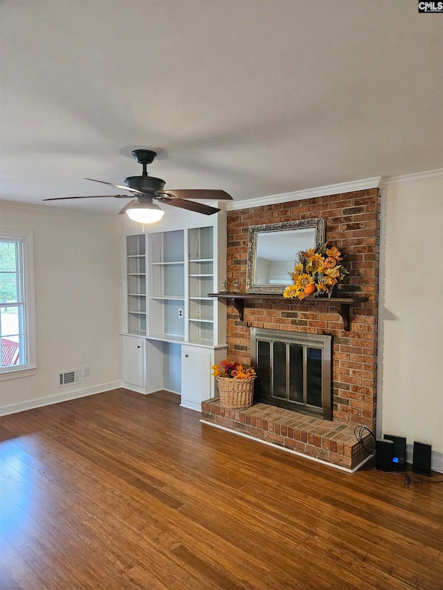 unfurnished living room featuring a fireplace, ornamental molding, and hardwood / wood-style floors