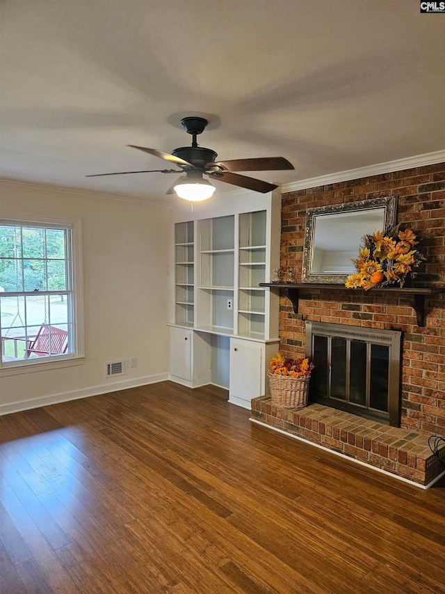 unfurnished living room featuring crown molding, ceiling fan, a fireplace, and wood-type flooring