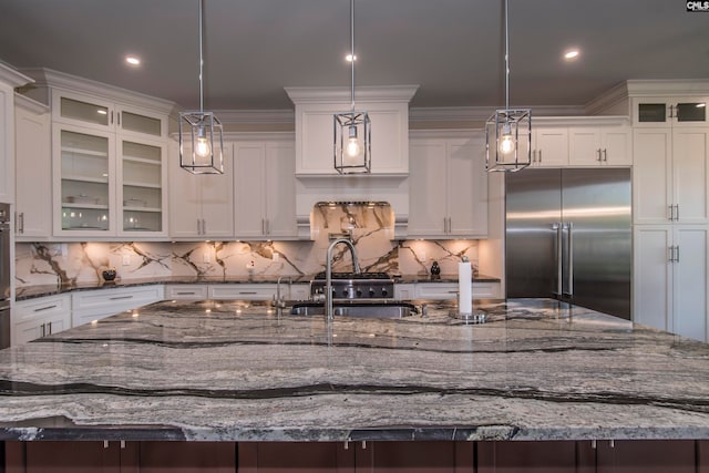 kitchen with pendant lighting, dark stone counters, and appliances with stainless steel finishes