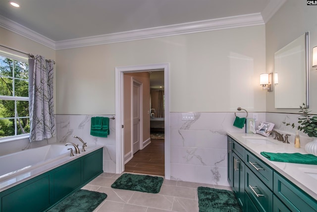 bathroom with vanity, tile walls, ornamental molding, tile patterned floors, and a bathtub