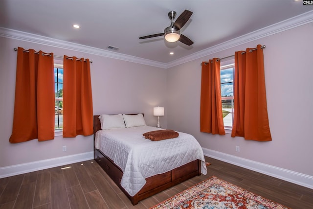 bedroom with dark wood-type flooring, ornamental molding, multiple windows, and ceiling fan