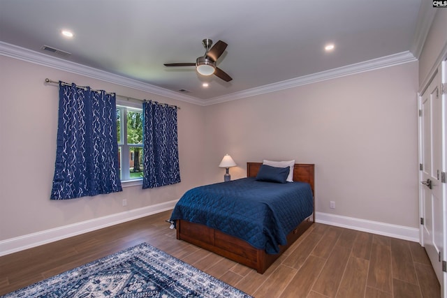 bedroom with ceiling fan, ornamental molding, and dark wood-type flooring