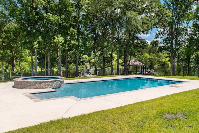 view of swimming pool with a yard and an in ground hot tub