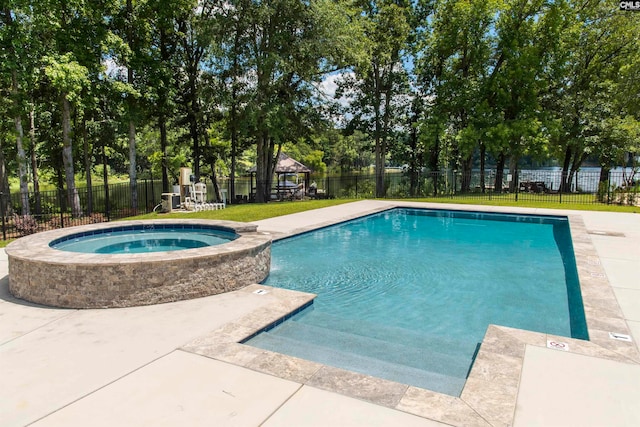 view of swimming pool featuring an in ground hot tub and a yard