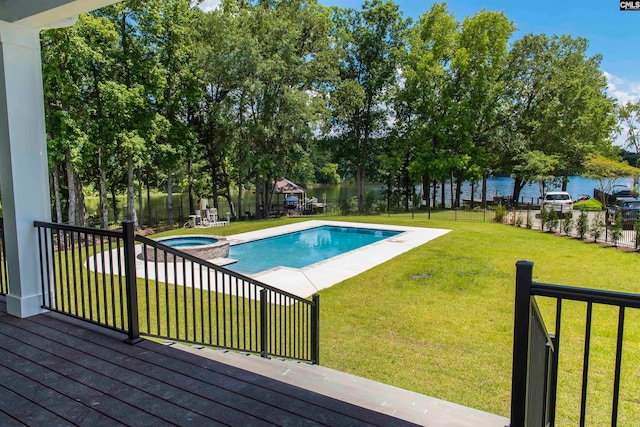 view of swimming pool with a yard and an in ground hot tub