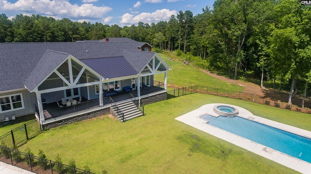 view of pool featuring an in ground hot tub, a patio, and a lawn