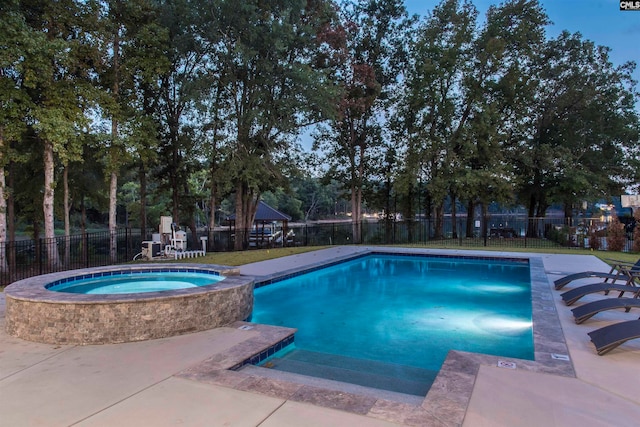 view of swimming pool with an in ground hot tub