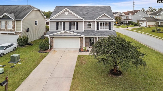 view of front of property with a garage and a front lawn