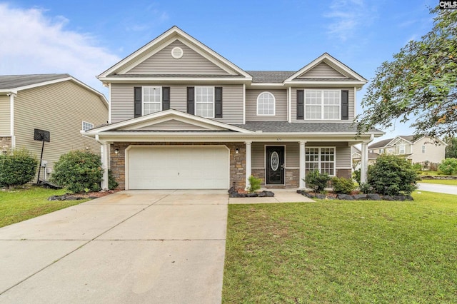 view of front of property featuring a front yard and a garage