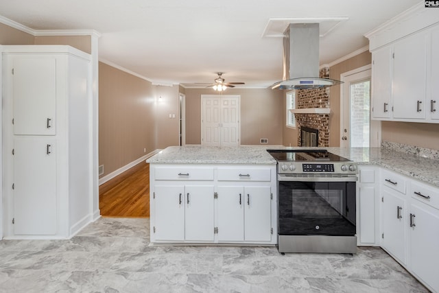 kitchen with electric range, kitchen peninsula, ornamental molding, white cabinets, and island range hood