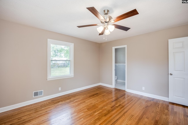 spare room featuring ceiling fan, wood-type flooring, and a textured ceiling