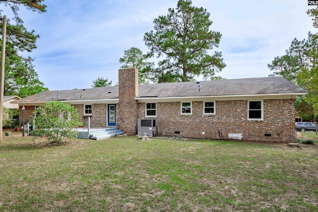 back of property with a deck and a lawn